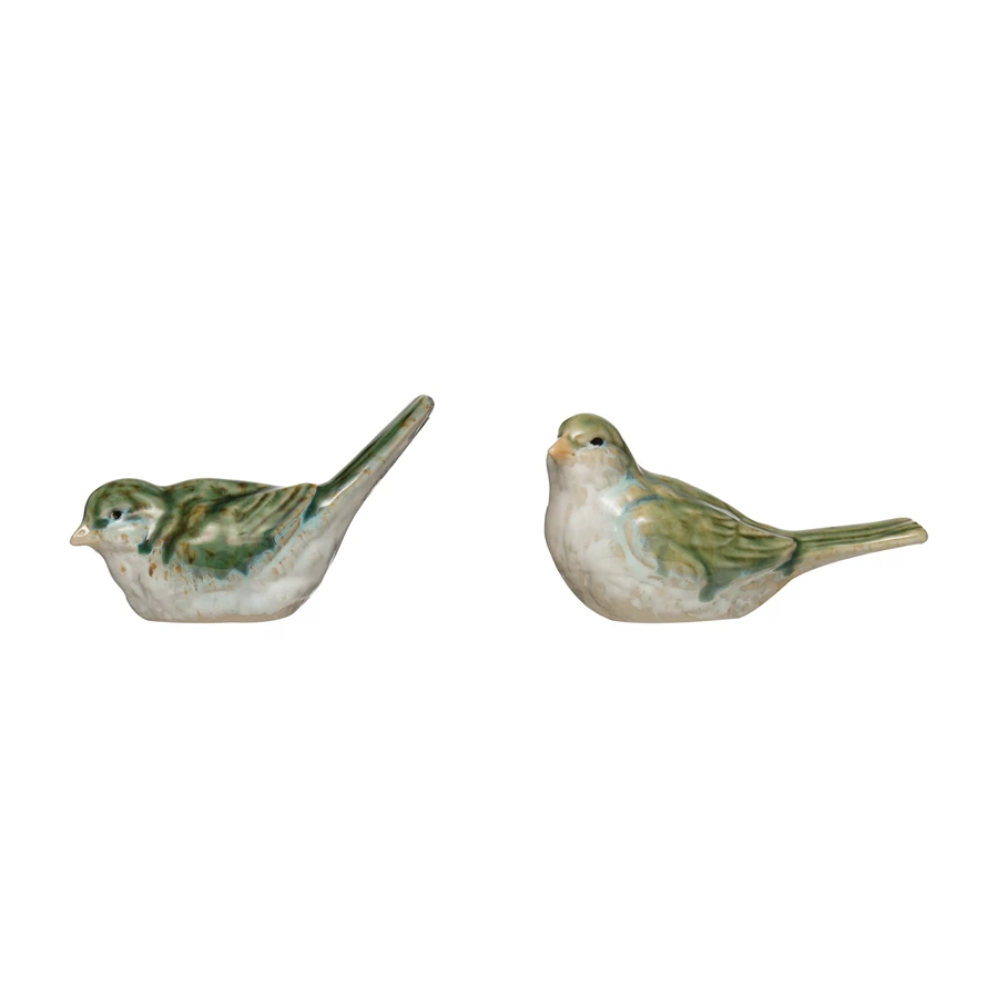 Stoneware bird figurine in natural earth tones with a smooth matte finish.