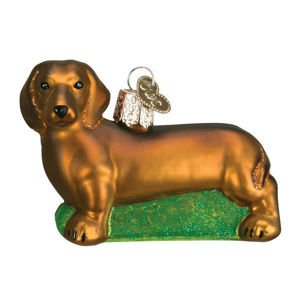 Red glass Christmas ornament shaped like a long-bodied dachshund with short legs.