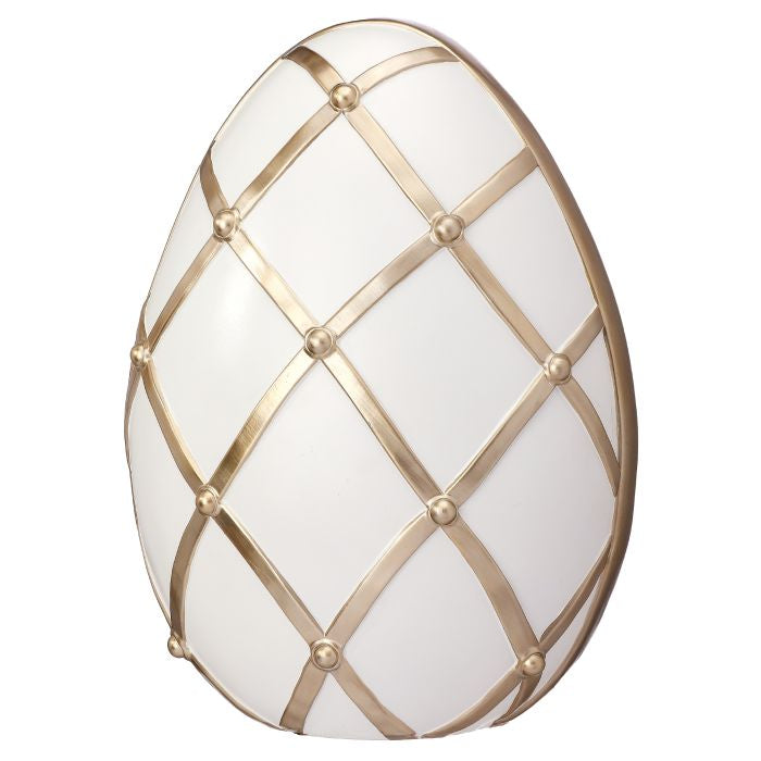 White resin lattice egg with a chocolate-colored interior visible through the openwork pattern.