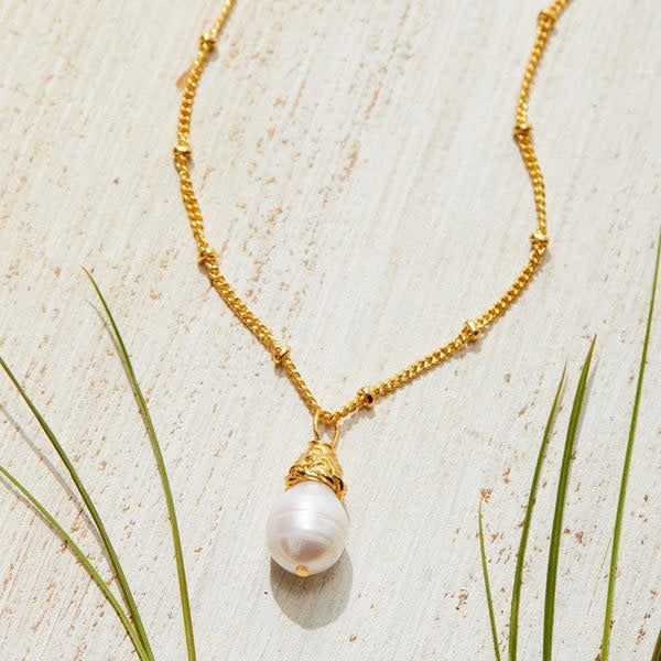 Dainty freshwater pearl drop necklace on a triple-plated gold chain with handmade craftsmanship.