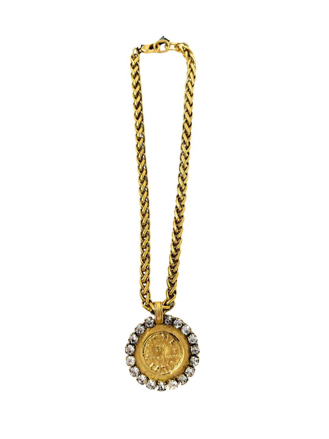 Gold chain necklace featuring a large coin pendant surrounded by clear rhinestones.