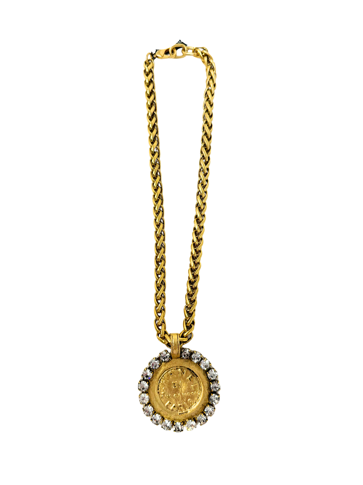 Gold chain necklace featuring a large coin pendant surrounded by clear rhinestones.