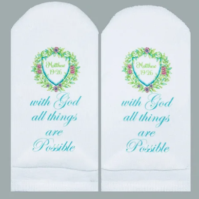 White no-show socks featuring a floral crest and the text 'with God all things are Possible'.