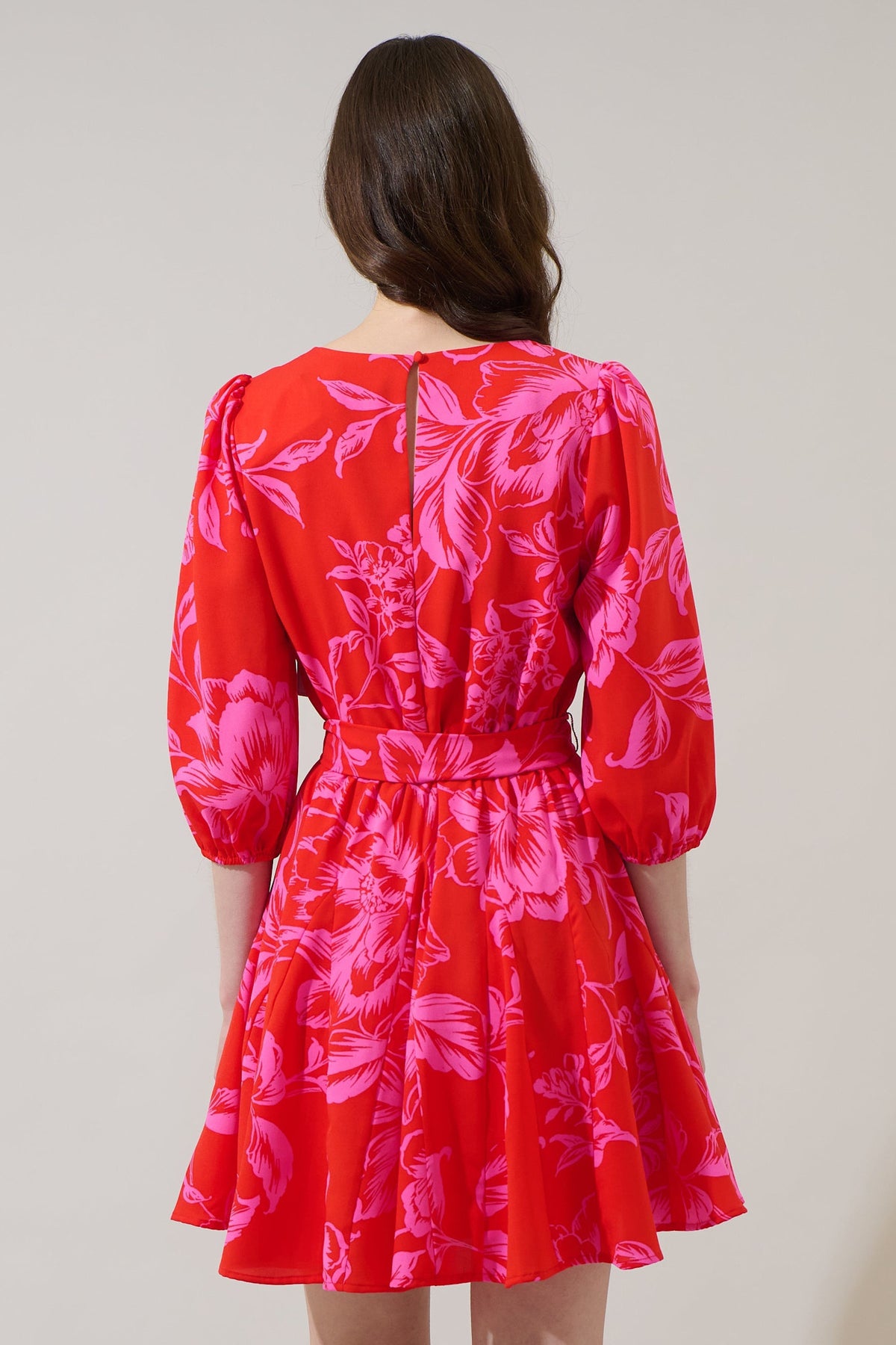 Red floral mini dress with balloon sleeves, fit-and-flare godet pleated skirt, and tie waist belt.