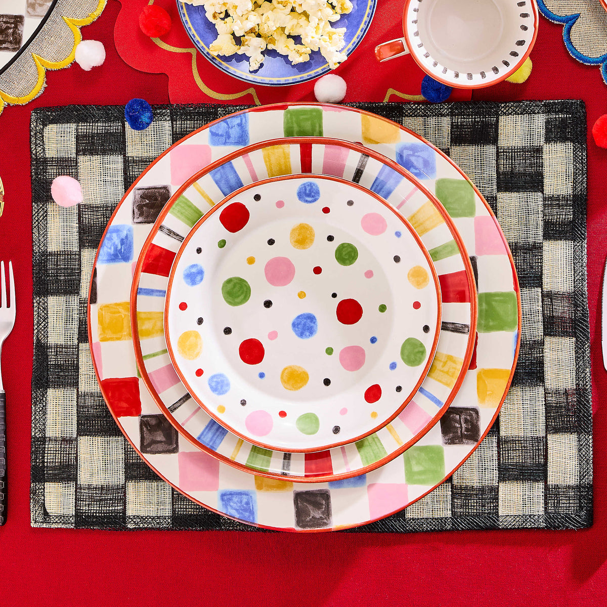 Handmade stoneware salad plate with playful carnival patterns in bright colors.