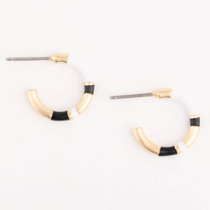 Layne hoop earrings in gold with alternating white and black enamel segments.