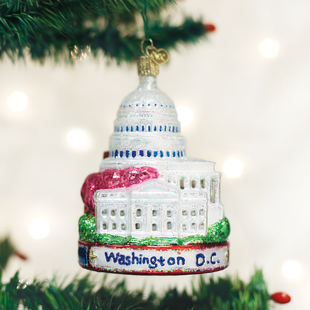 Red ceramic Washington D.C. ornament featuring white silhouettes of the Capitol Building and Lincoln Memorial.