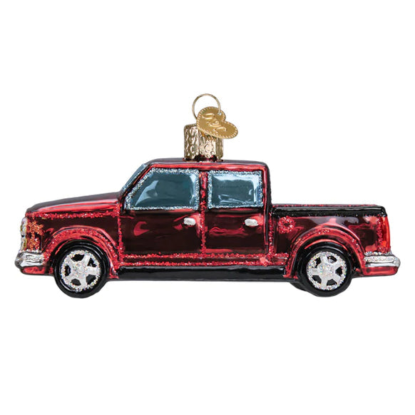 Red glass pickup truck Christmas ornament with glitter accents and silver wheels.