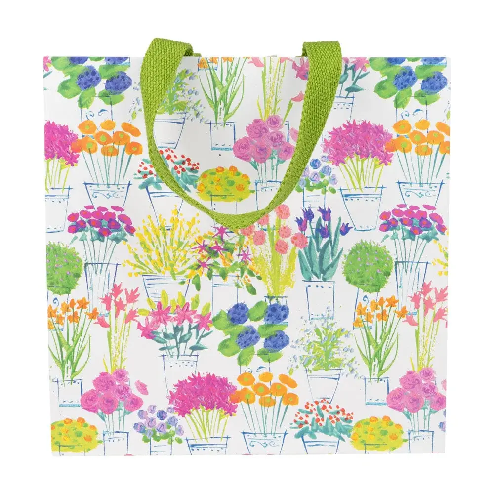 Medium square gift bag with floral market print on durable paper featuring a strong carrying handle.