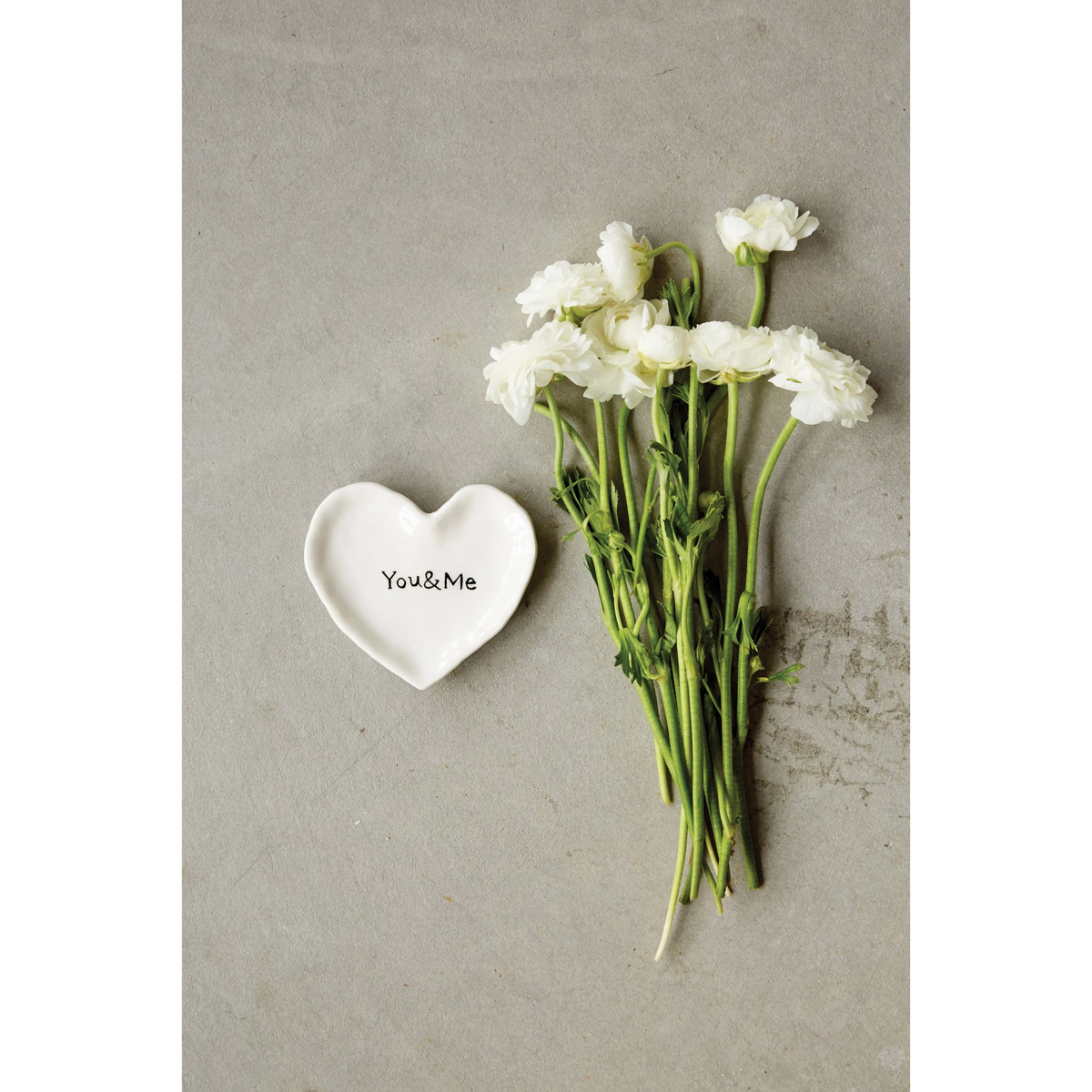 Ceramic heart-shaped dish in white with a subtle textured finish.