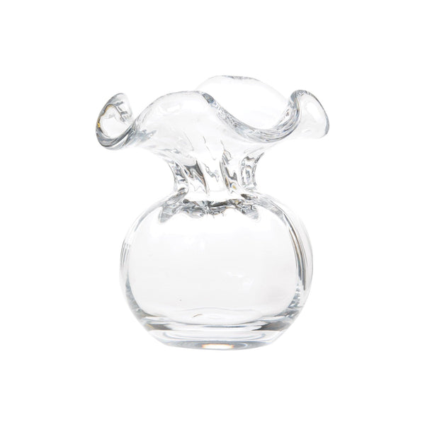 Clear glass bud vase with hibiscus-inspired hue holding a single stem