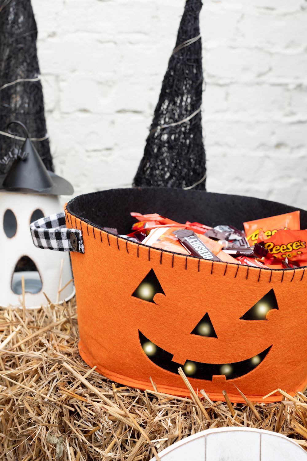 Reversible felt bucket with a ghost on one side and jack-o-lantern pattern on the other.