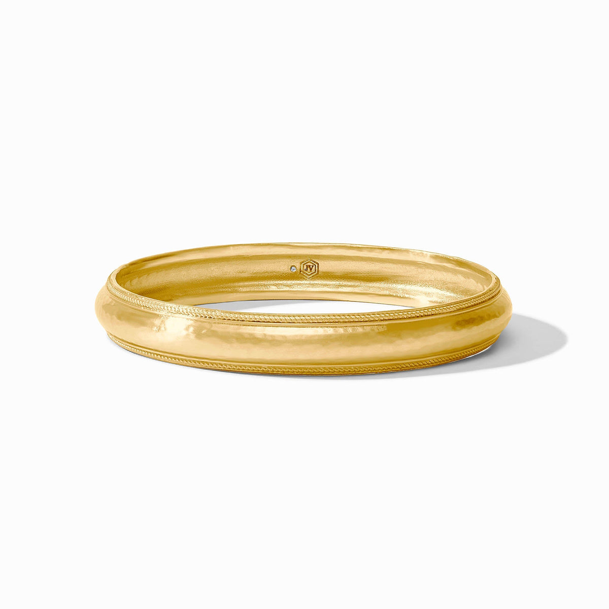 Cannes bangle in gold-tone metal with a smooth cylindrical shape.