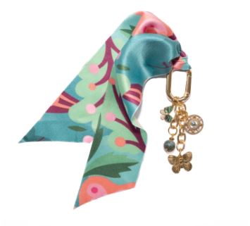 Costa floral bag charm featuring a small pendant with colorful flower pattern on gold-tone metal.