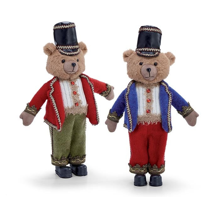 Plastic nutcracker bear figurine with fabric accents in festive holiday colors.