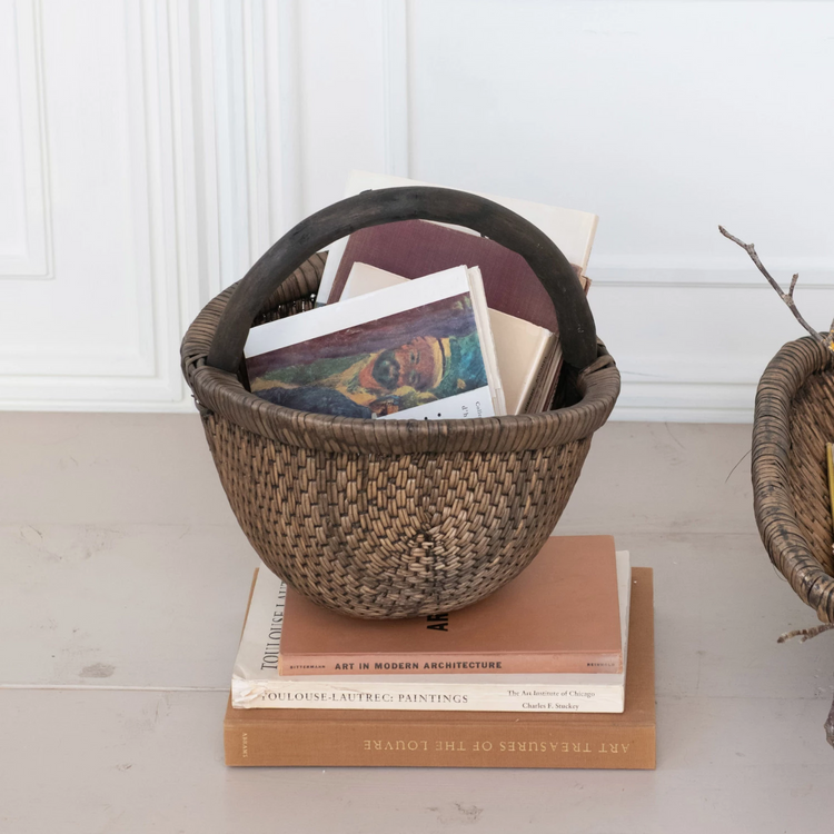 Oval hand-woven wicker basket in brown willow wood with an antique finish.
