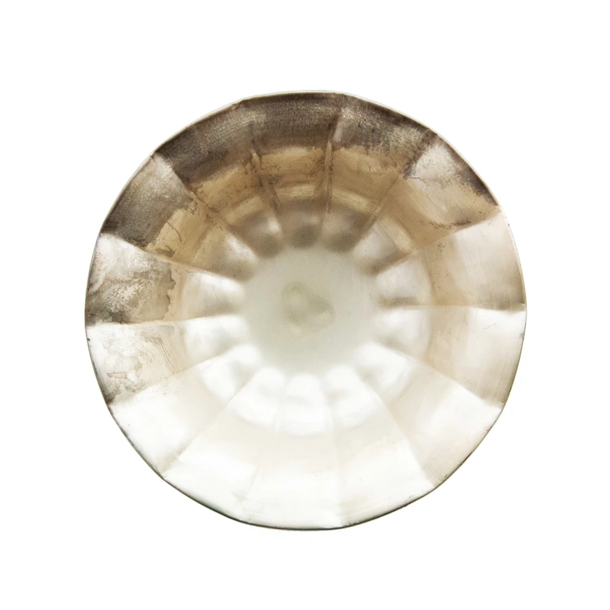 Footed metal bowl with ruffled edges in distressed gold finish