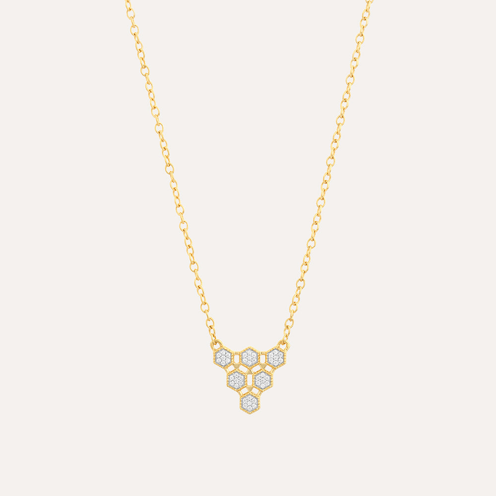 Gold honeycomb pendant necklace with diamond accents on a delicate chain.