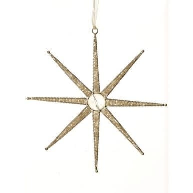 Champagne-colored star-shaped ornament with intricate Southwestern patterns.