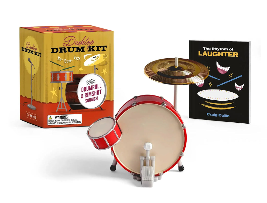 Desktop drum kit replica with snare, base drums, cymbal, and included comedy book.