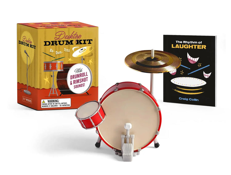 Desktop drum kit replica with snare, base drums, cymbal, and included comedy book.