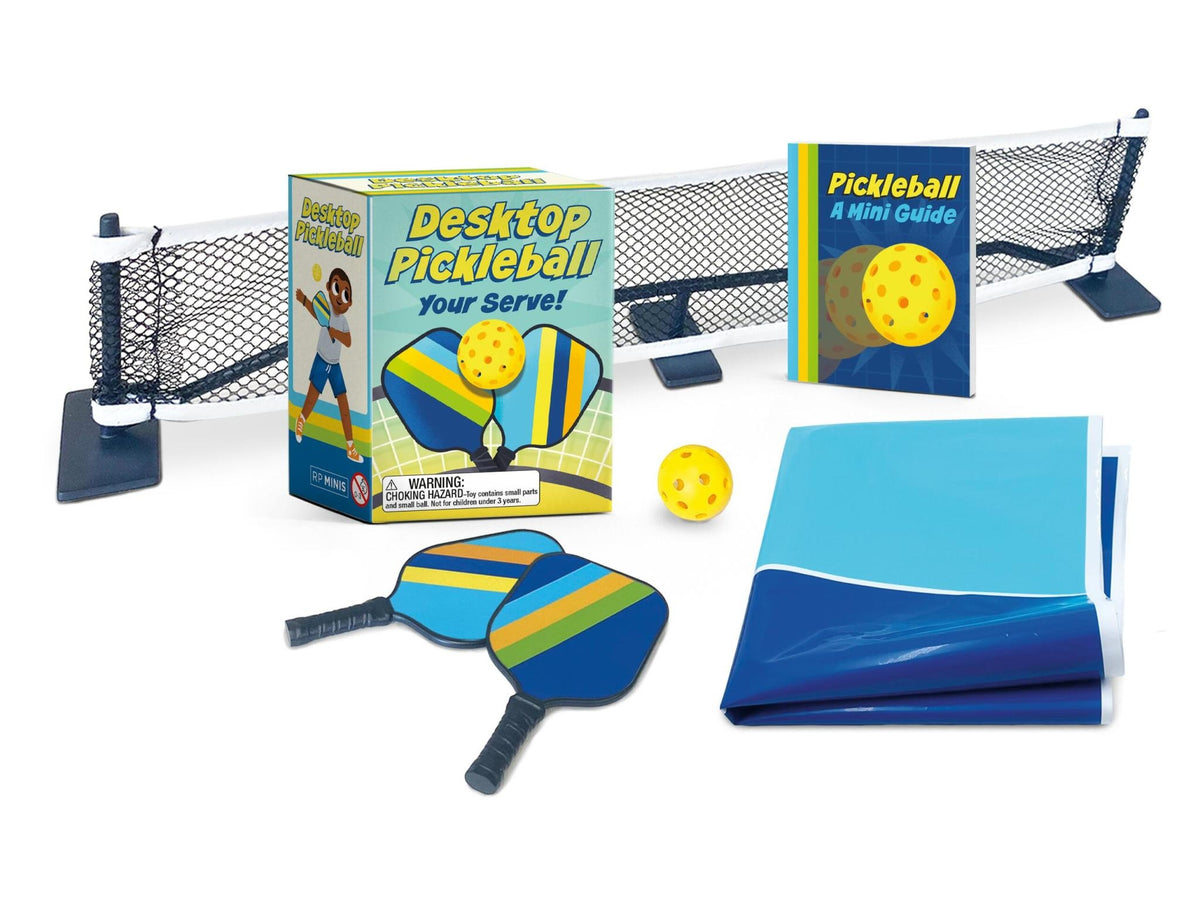 Desktop Pickleball set with miniature rackets, net, ball, mat, and illustrated rulebook.