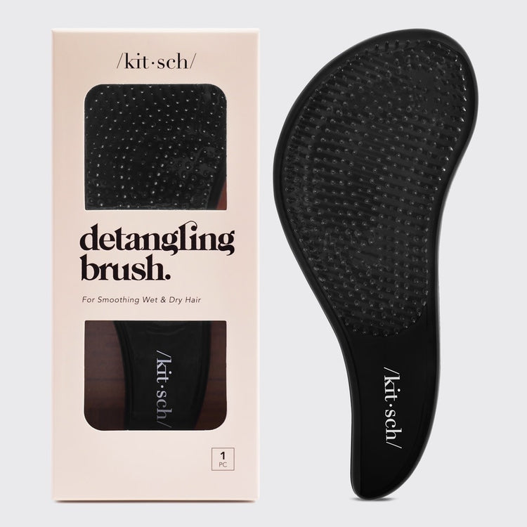 Black detangling brush with flexible bristles designed to smooth tangles.