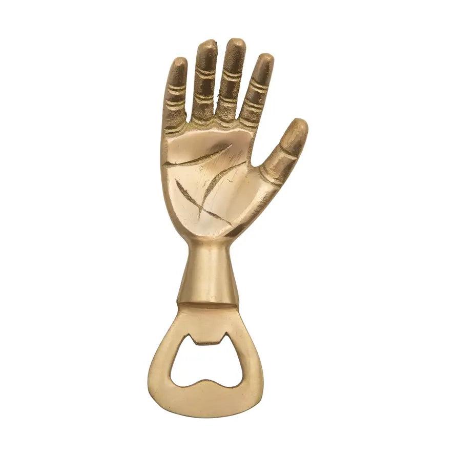 Brass hand bottle opener with a curved handle and lever mechanism.