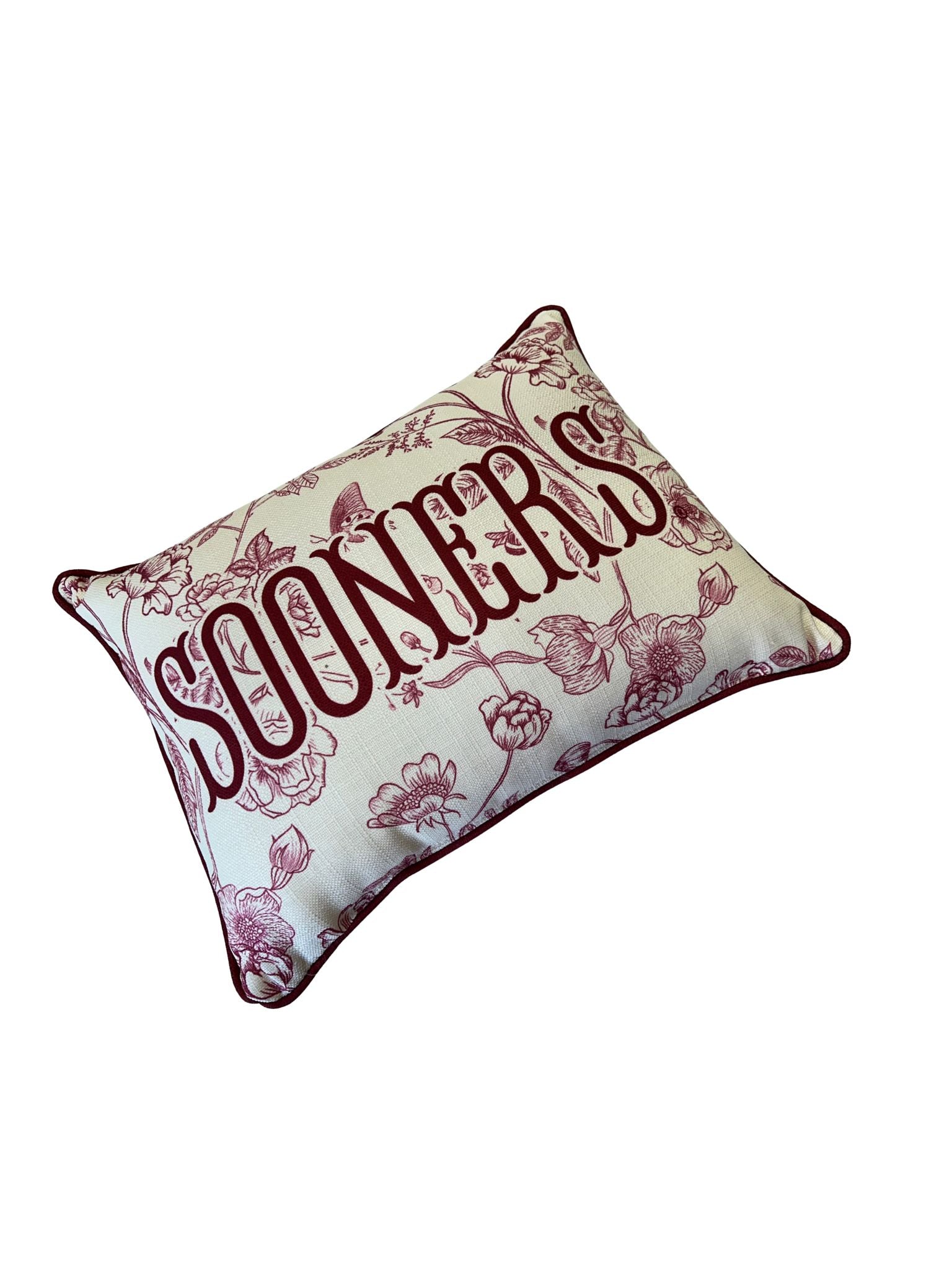 Rectangular cream pillow with maroon floral toile pattern and "SOONERS" text in the center.