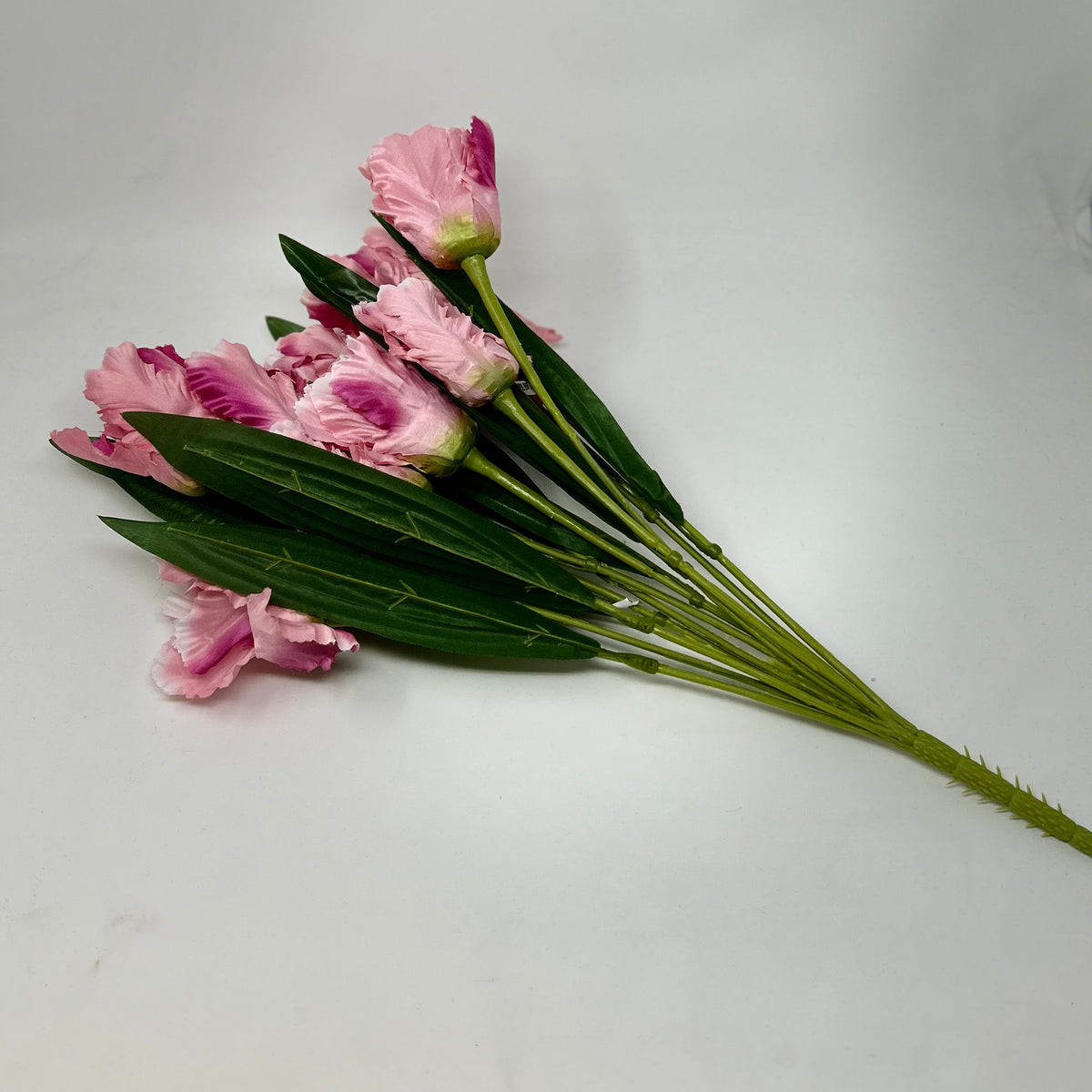 A bouquet of 12 artificial pink tulip bushes with green leaves and spiky stems.