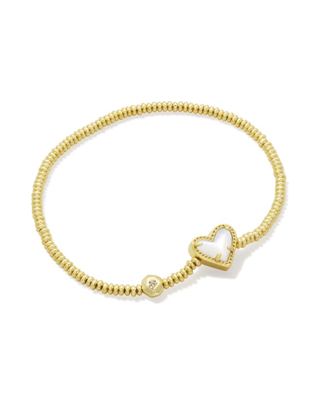 Stretch bracelet in yellow gold over brass with a heart-shaped charm.
