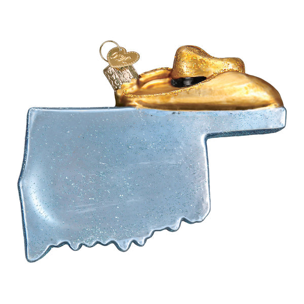Glass Oklahoma state ornament with a blue glittered map and a gold cowboy hat on top.