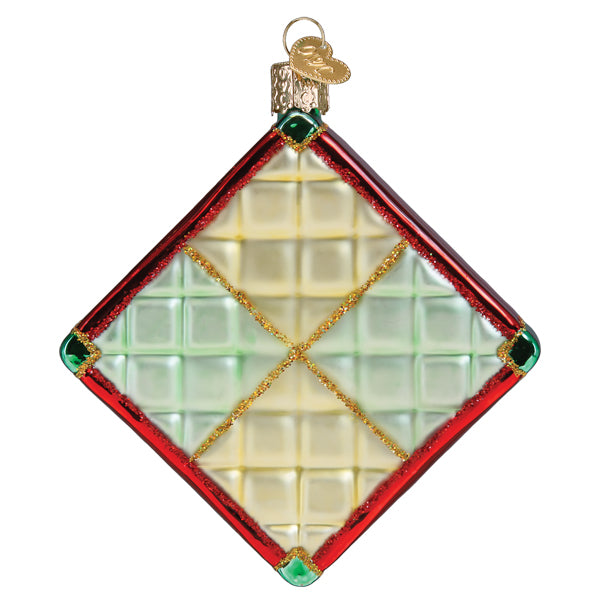 Diamond-shaped glass Christmas quilt ornament with red borders and gold glitter accents.