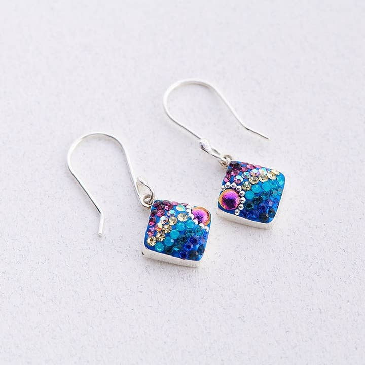 Sterling silver drop earrings featuring a diamond-shaped silhouette filled with sparkling Austrian crystals.