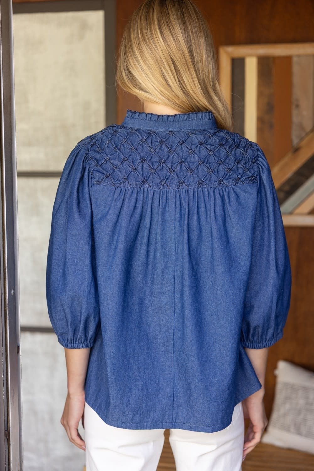 Back view of a relaxed denim top with diamond-textured yoke detail.