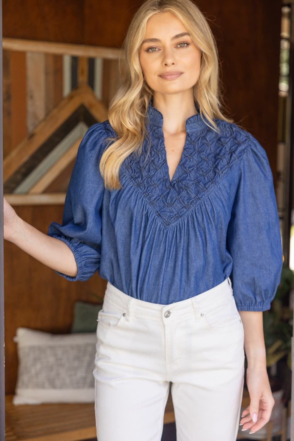 Solid denim quarter puff sleeve top with diamond textured yoke and V-neckline