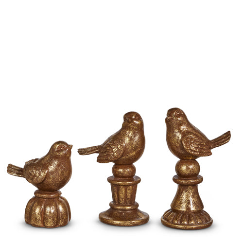 Antique brass resin bird figurines on pedestals with naturalistic silhouettes and textured finish.