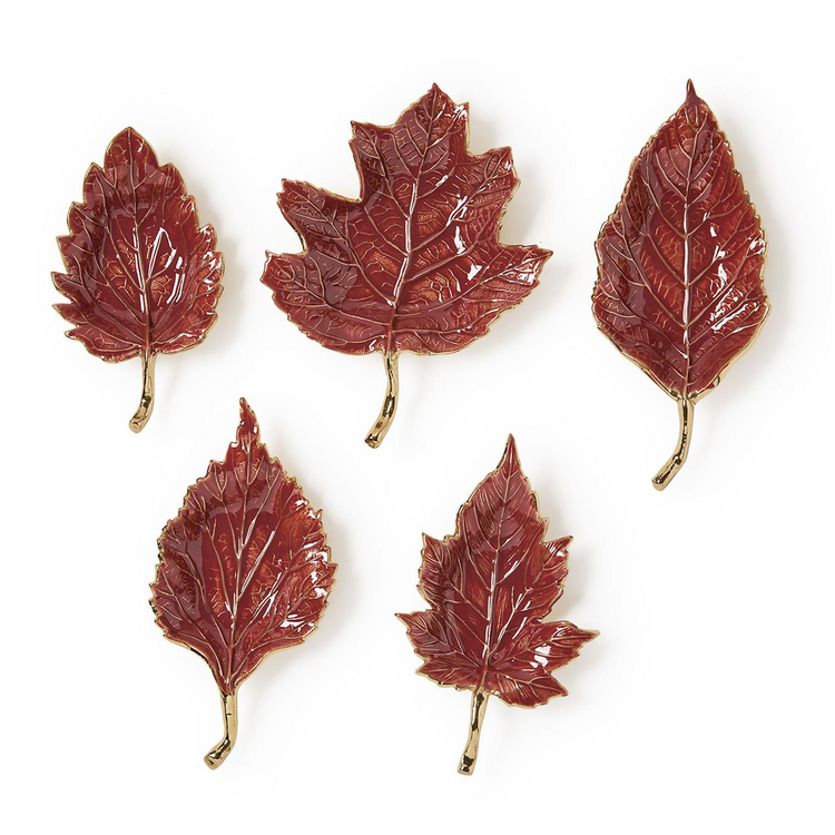 Set of five red enameled leaf trays with gold-toned stems and textured vein details.