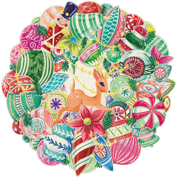 Die-cut wreath placemat with vintage ornament bauble patterns in festive colors on white paper.