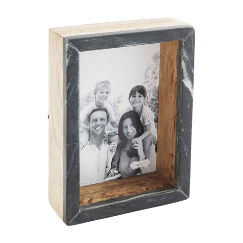 Black marble shadow-box frame holding a 5x7 photo with natural stone veining.
