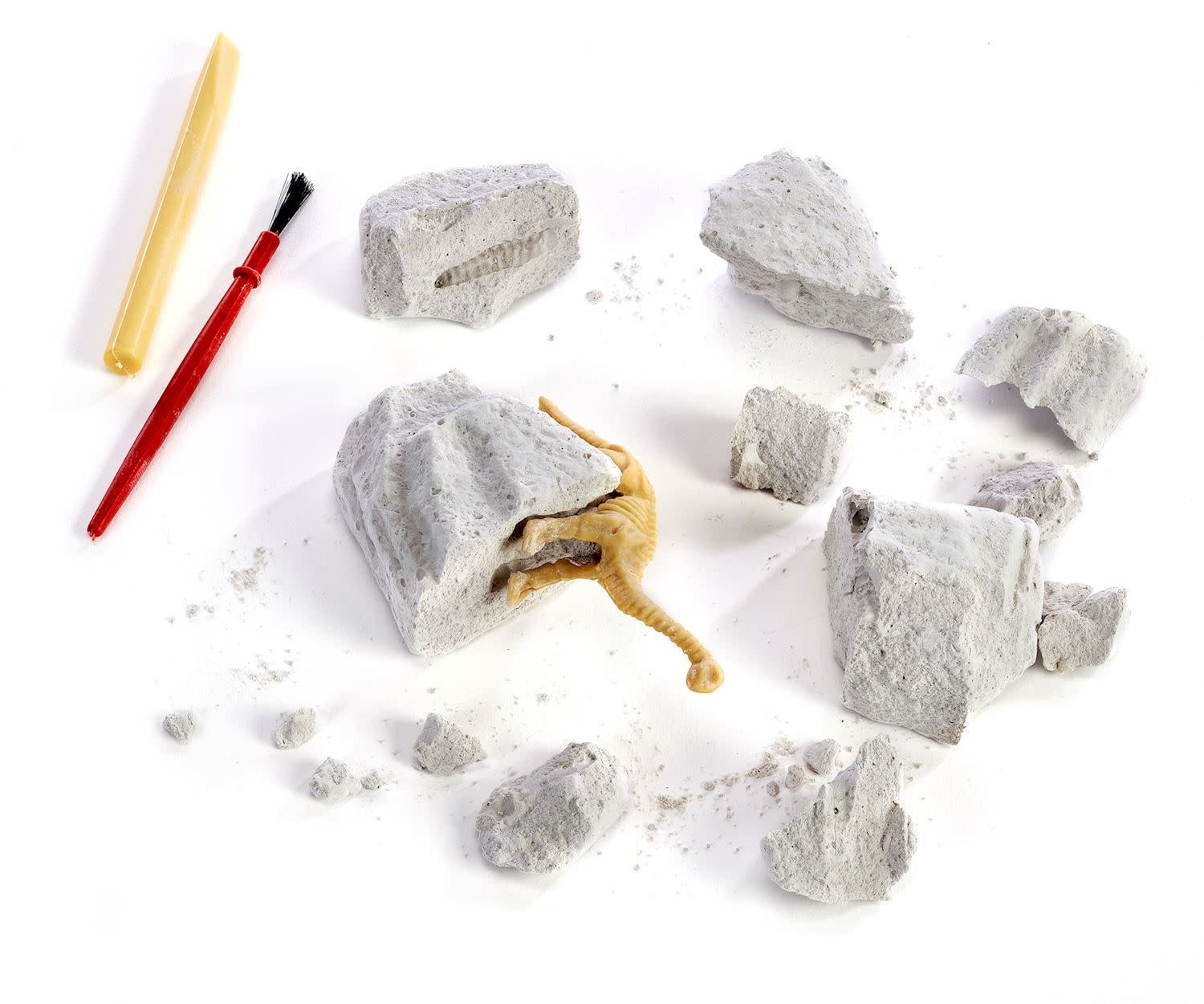Hand excavation kit with crumbly gypsum nugget containing a faux fossilized dinosaur skeleton.