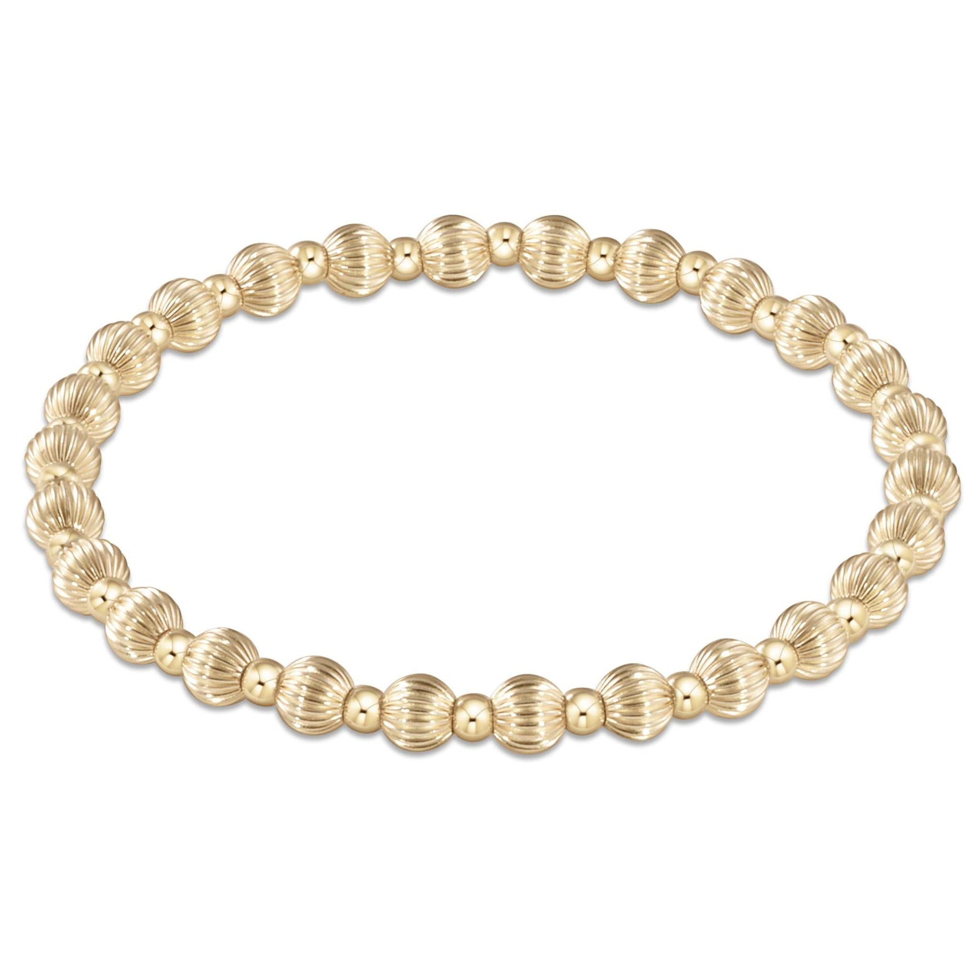 Gold-filled Dignity bracelet with a grateful bead pattern on elastic cord