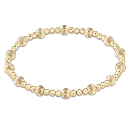 Gold-filled bracelet with 3mm round beads mixed with larger dignity sincerity pattern beads on elastic cord