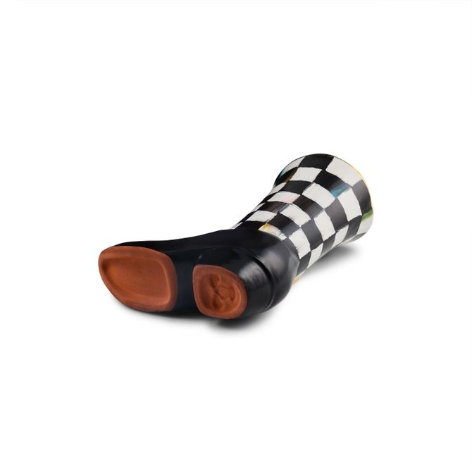 Bottom view of a ceramic cowboy boot bud vase with a black and white checkered pattern.