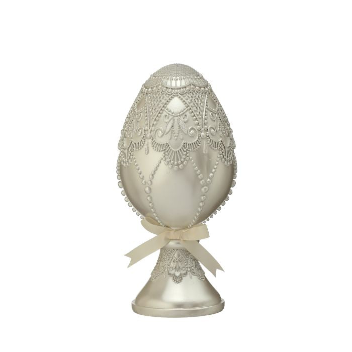 Twelve-inch resin pedestal egg with bead embellishments in a fancy finish.