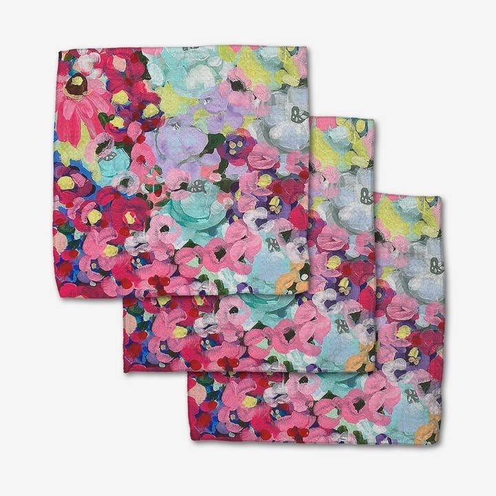 Set of three pink waffle weave dishcloths with single-sided print fields of joy pattern and hang loops.