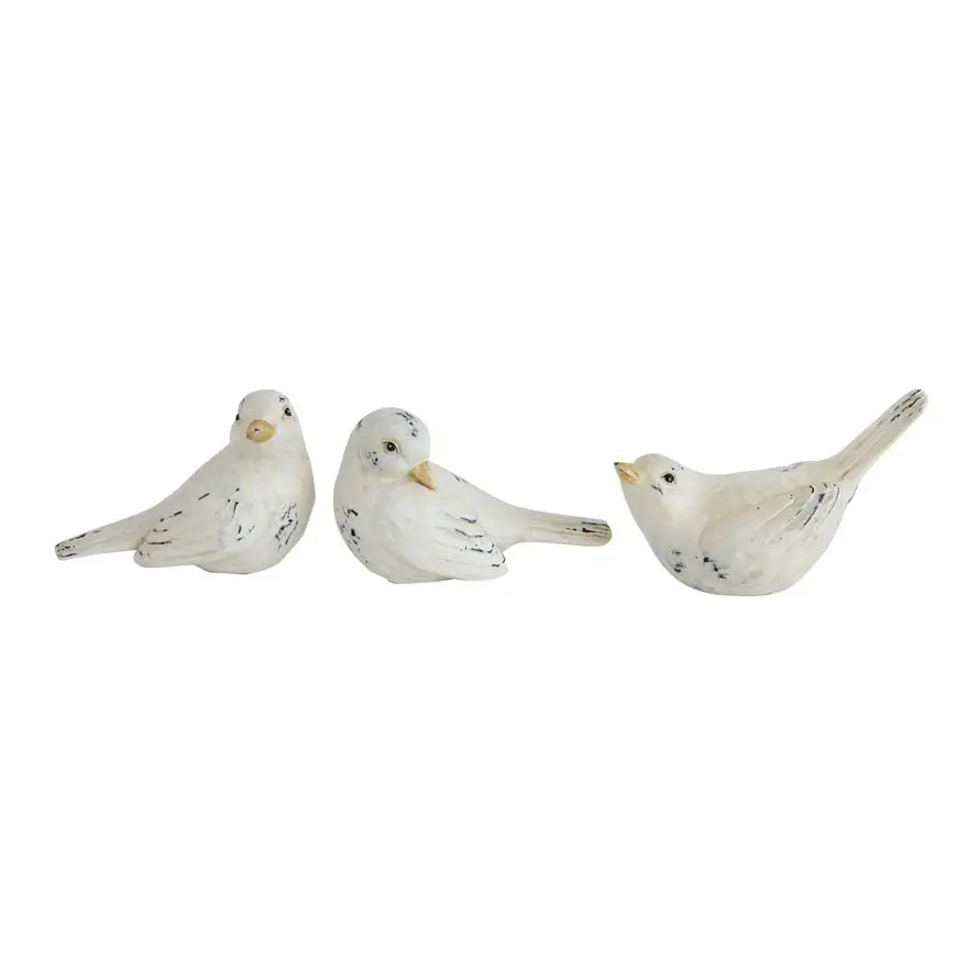 Distressed resin bird figurine with a natural wood grain finish.