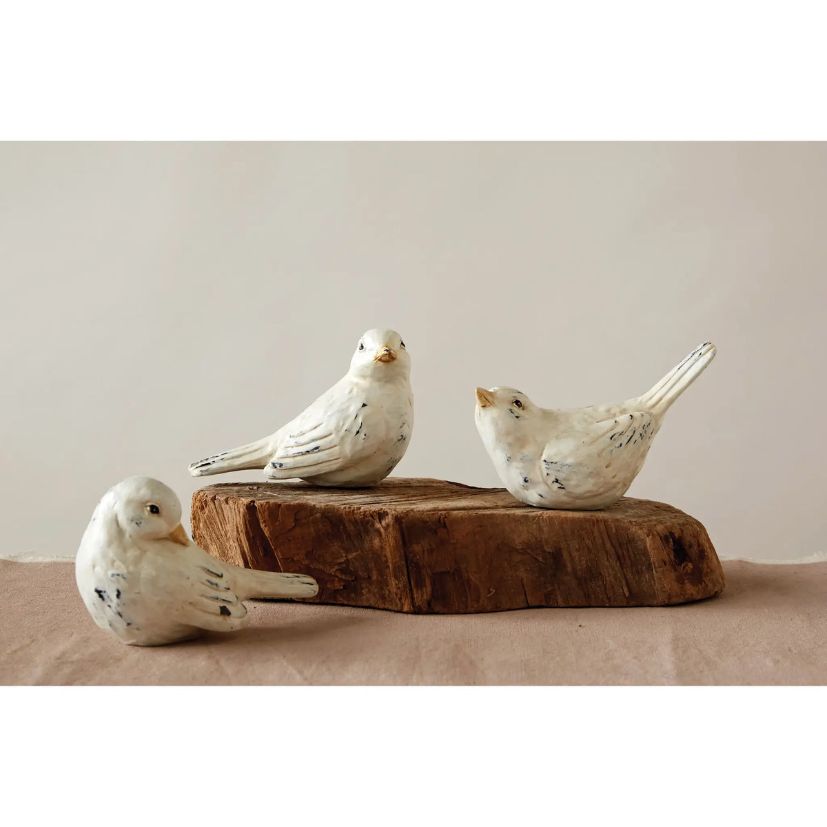 Distressed resin bird figurine with a natural wood grain finish in earthy brown tones.