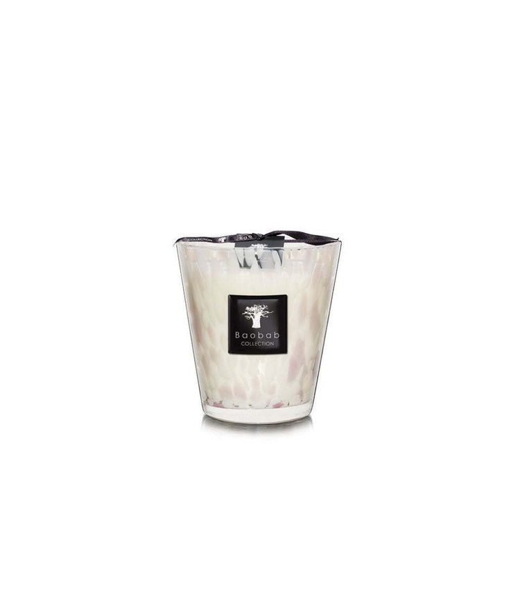 Baobab Collection White Pearls candle in a hand-blown glass vessel with pink and white highlights.