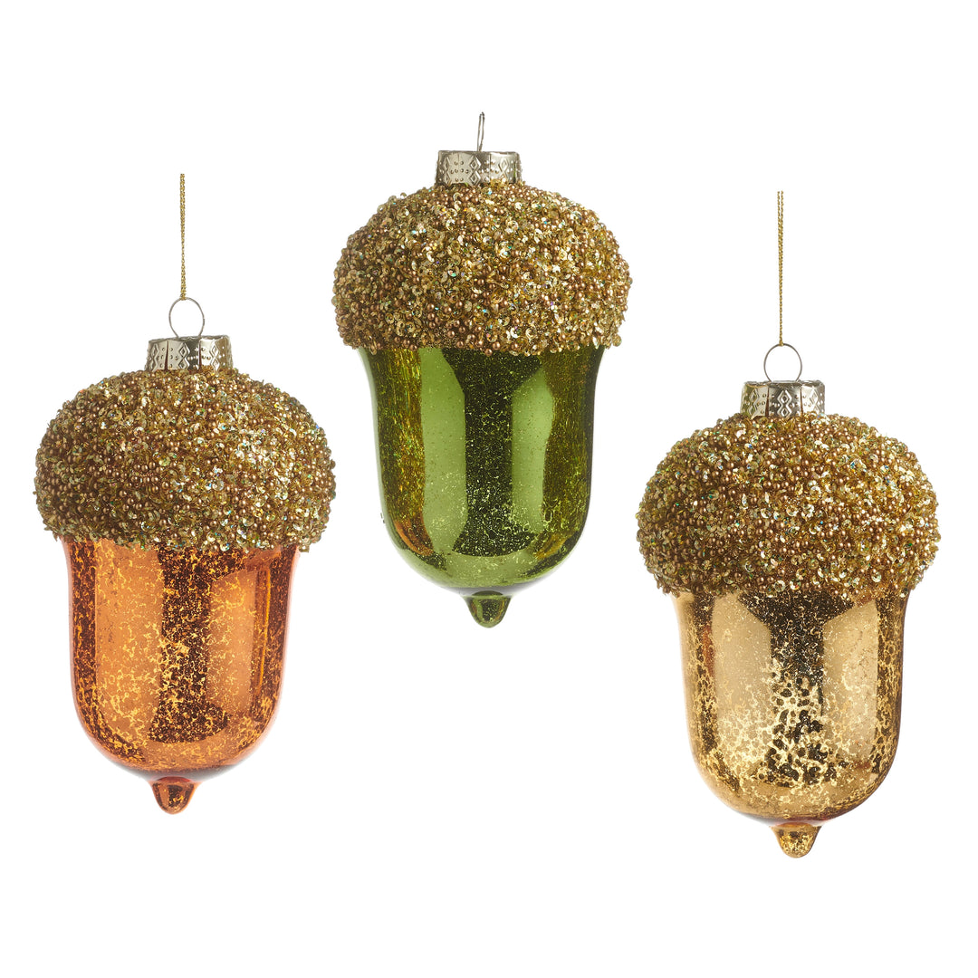 Three 5-inch glass acorn ornaments in orange, green, and gold with beaded tops.